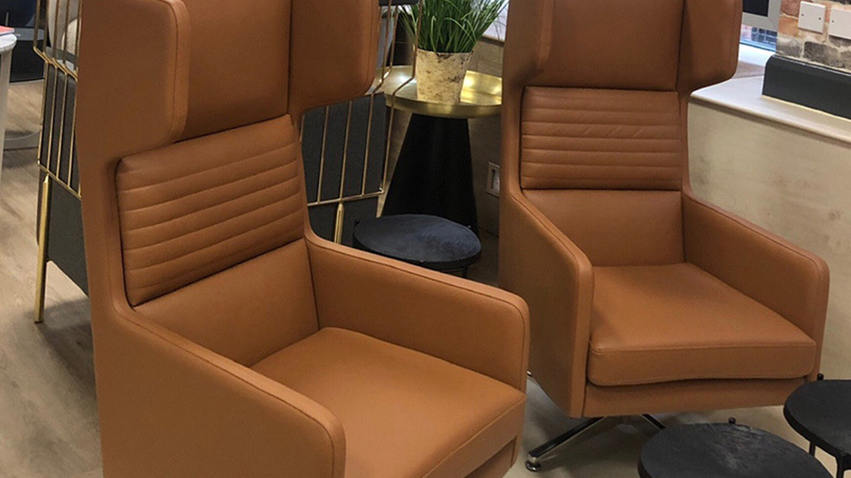 Two OB&B Hydde Swivel Chairs Brown Upholstery In Lounge Setting