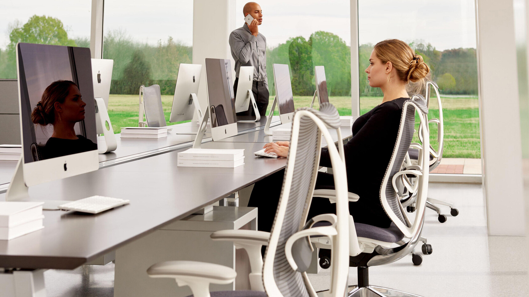 Four Okamura Sabrina Office Chairs Light Grey White Frame With Additional Lumbar Support White Grey 4-D Adjustable Arms Polished Base Chair In Use At Desks