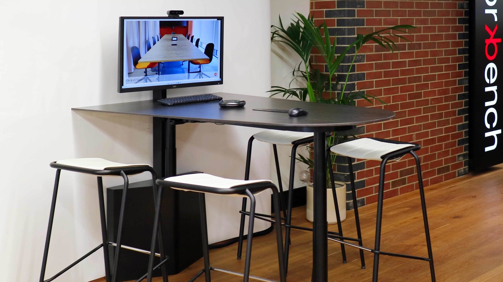 Workbench Pogo Shaped Rise and Fall AV Table In Office Setting