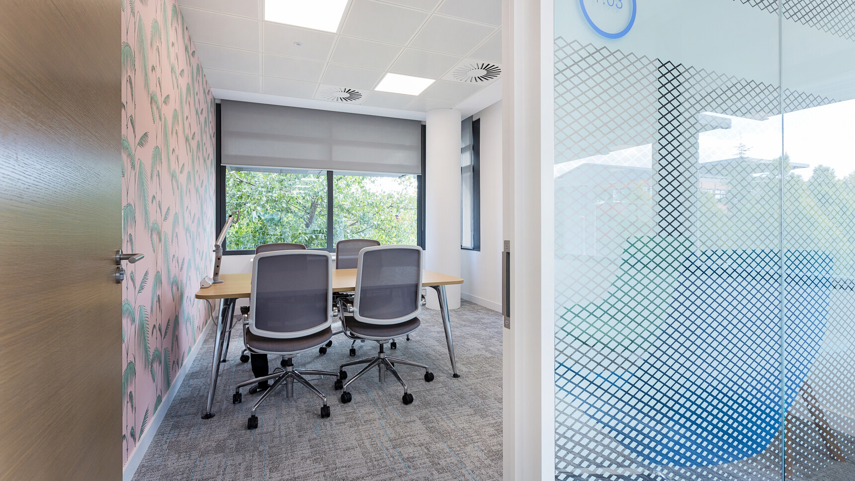 Four Boss Design Trinetic Upholstered Office Chairs With Dark Grey Upholstery With Grey Frame Backrest And Polished Aluminium Armrests And Polished Aluminium Base On Castors At Desk In Office Environment