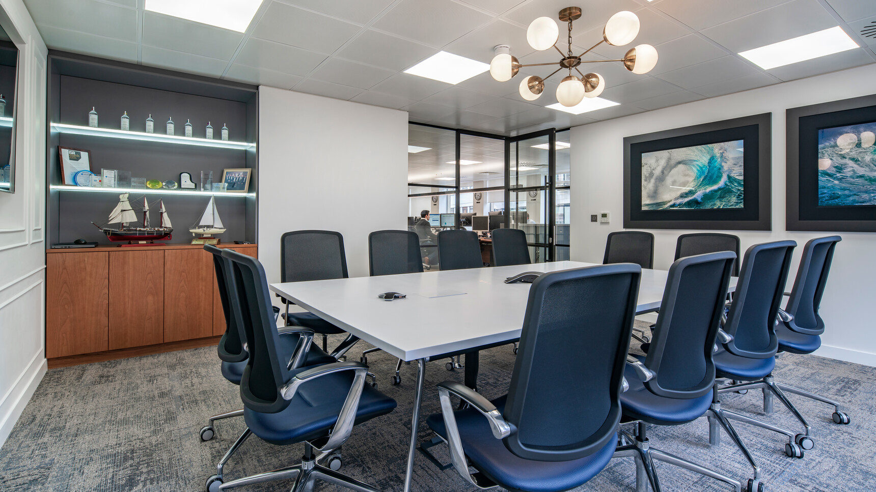 Twelve Boss Design Trinetic Mesh Seat & Back Office Chairs In Blue Upholstery With Polished Aluminium Armrests With Black Seat Edges And Polished Aluminium Base At Desk