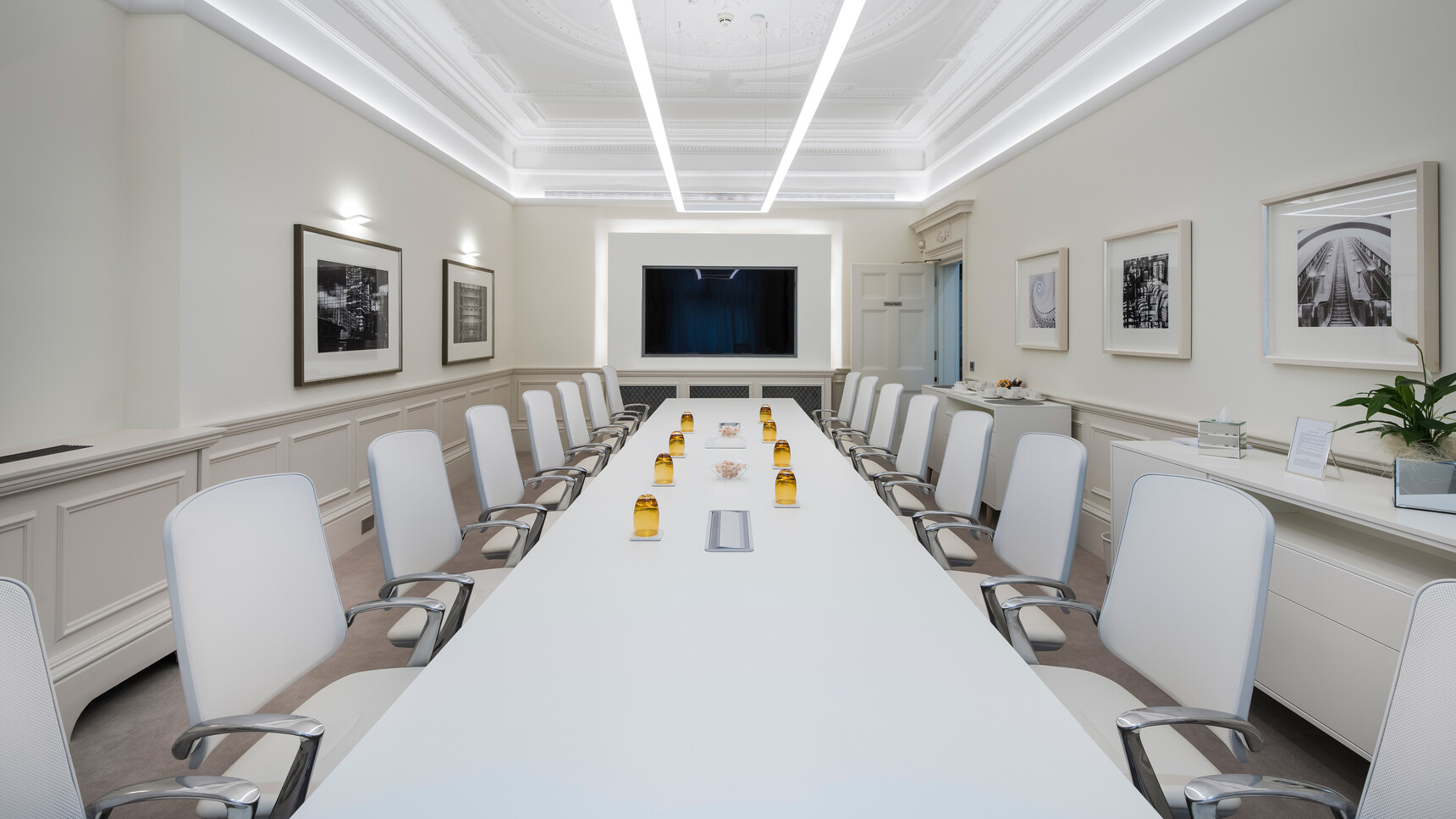 Eight Boss Design Trinetic Upholstered Office Chairs With White Upholstery And Grey Seat Edges And Polished Aluminium Base At Conference Table