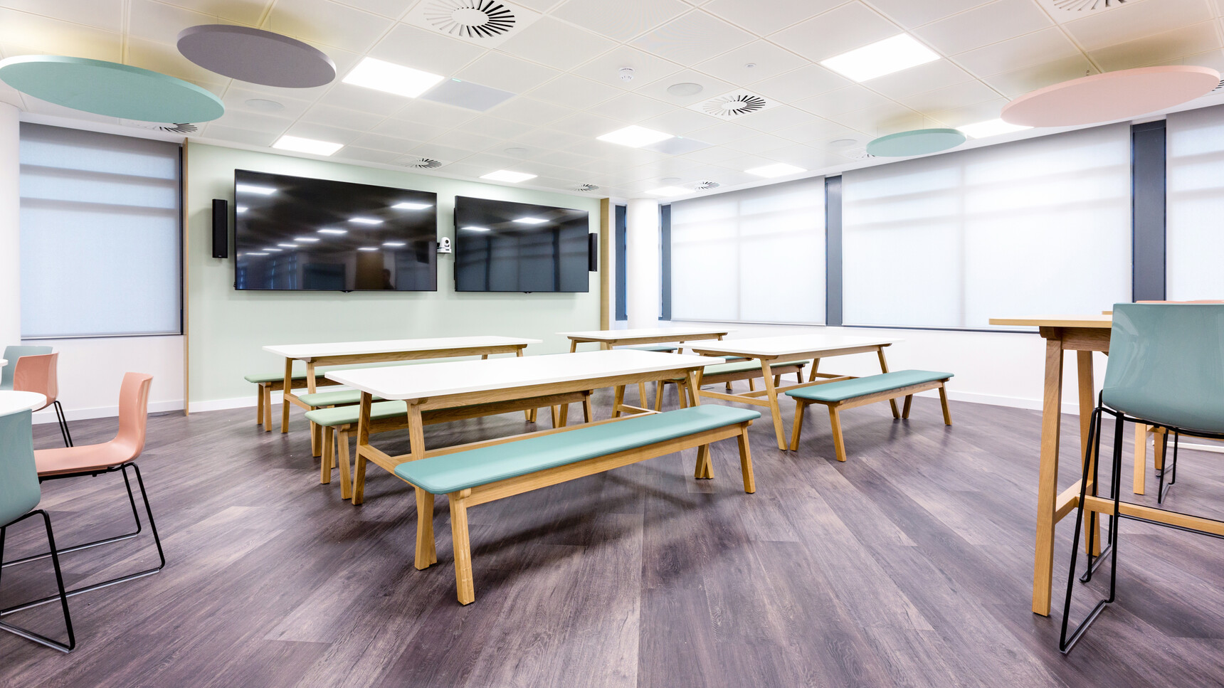 Eight Boss Design Agent Benches Two In Blue Upholstery And Six In Light Green Upholstery With Timber Four Leg Wooden Base Finish At Agent Four Leg Tables With White Table Top Finishes And Wood Finishes