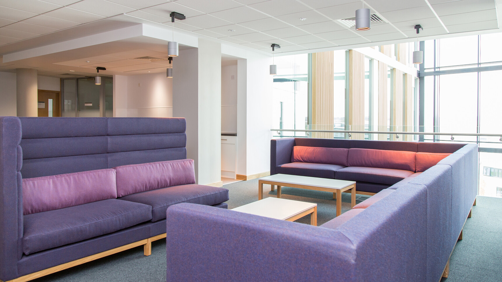 Boss Design Arthur Cityscape With Blue Upholstery With Wood Base Finish With High And Low Seating And Purple Cushions In Two Sections At Two Coffee Tables