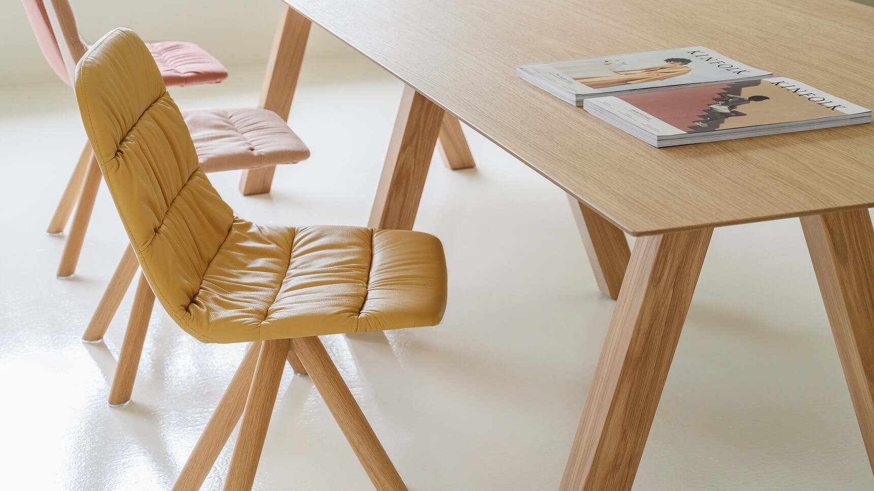 Viccarbe Maarten Soft Upholstered Chairs With Wood Swivel Base At Table Detail