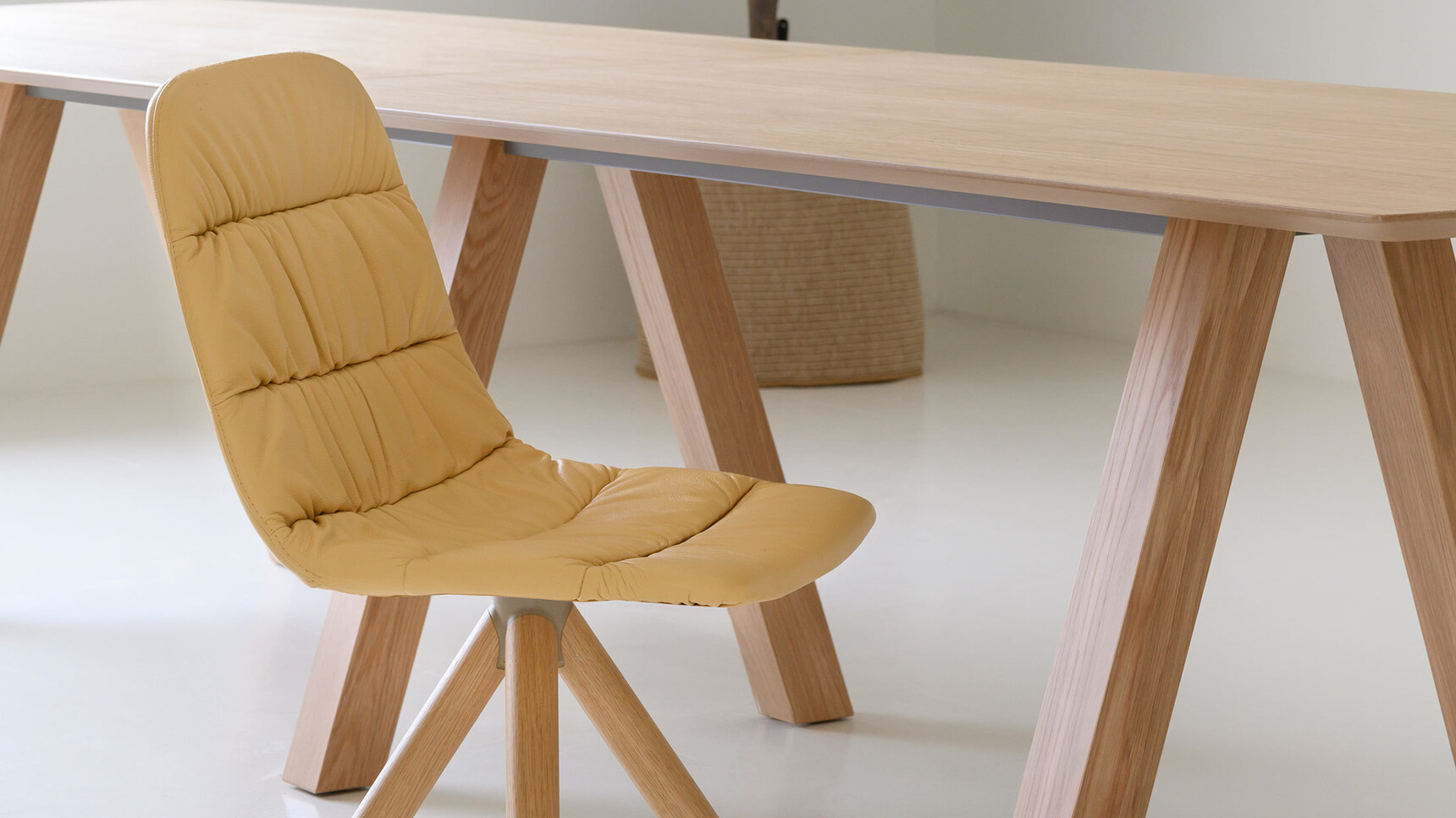 Viccarbe Maarten Soft Upholstered Chair With Wood Swivel Base At Table Detail