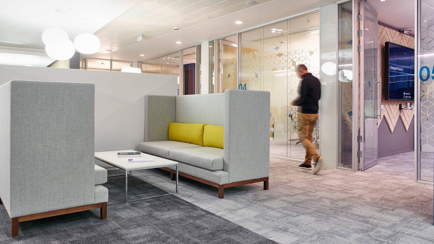 Two Boss Design Arthur Large Sofas In Grey Upholstery And Dark Wood Finish And Yellow Cushions At Coffee Table