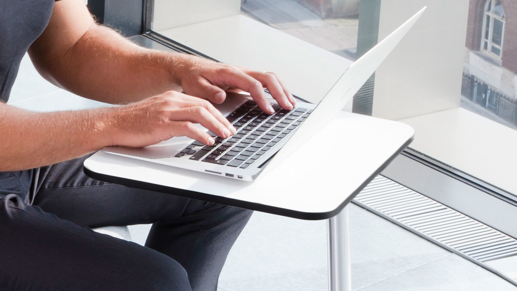 Boss Design Flamingo Laptop Table With White Finish In Use By A Person On Their Laptop