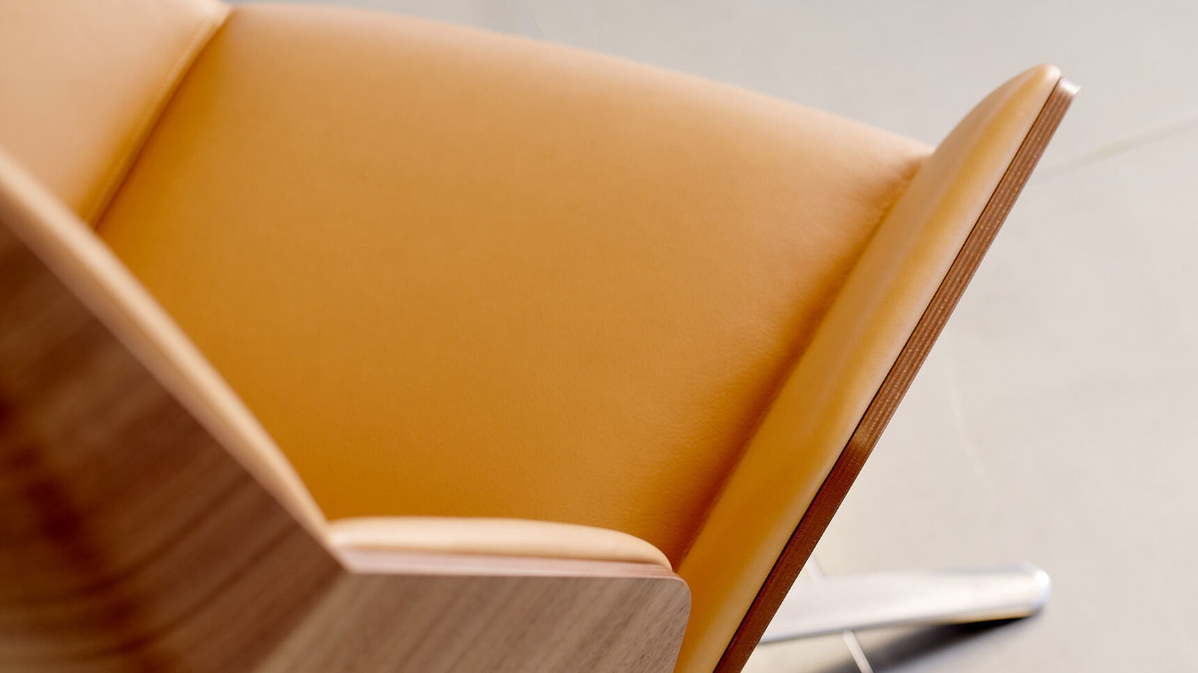 Boss Design Kruze Lounge High Back Chair With Orange Leather Upholstery And Wood Frame And Polished Aluminium Base Overhead Detail Image