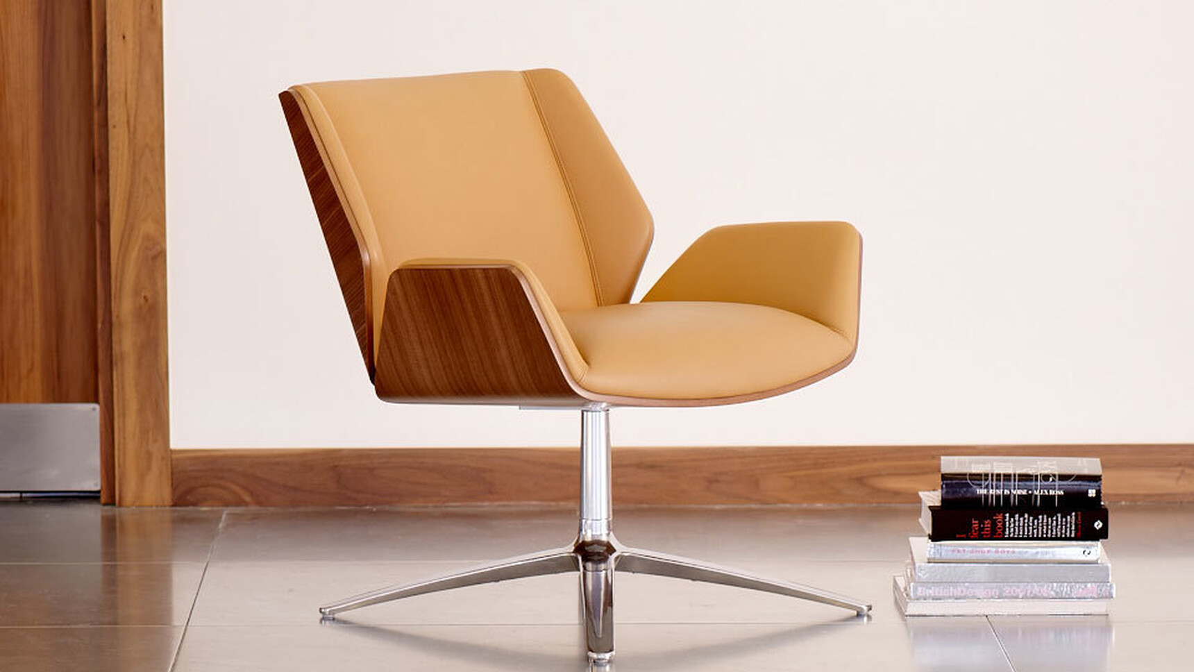 Boss Design Kruze Lounge Low Back Chair With Brown Leather Upholstery And Wood Frame Finish And Polished Chrome Base With Books By Chair