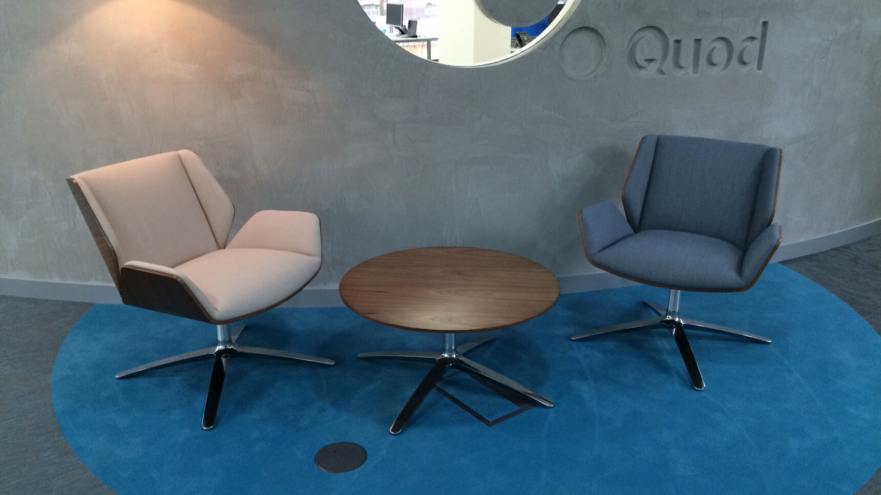 Two Boss Design Kruze Lounge Low Back Chairs One In Blue Upholstery And One In White Upholstery With Wood Frame Finishes And Polished Chrome Base At Table With Wood Table Top Finish And Polished Chrome Base