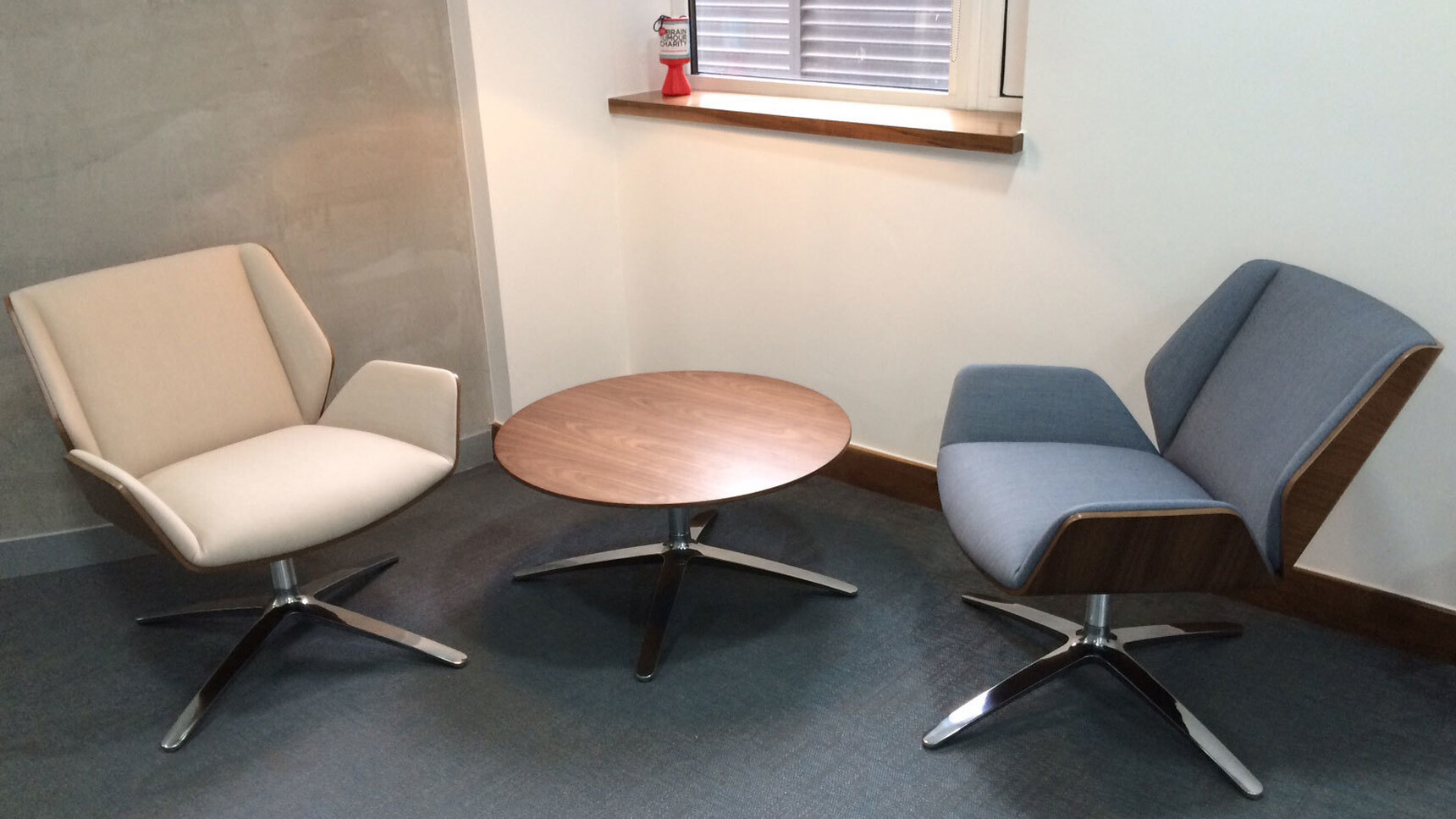 Two Boss Design Kruze Lounge Low Back Chairs One In Blue Upholstery And One In White Upholstery With Wood Frame Finishes And Polished Chrome Base At Table