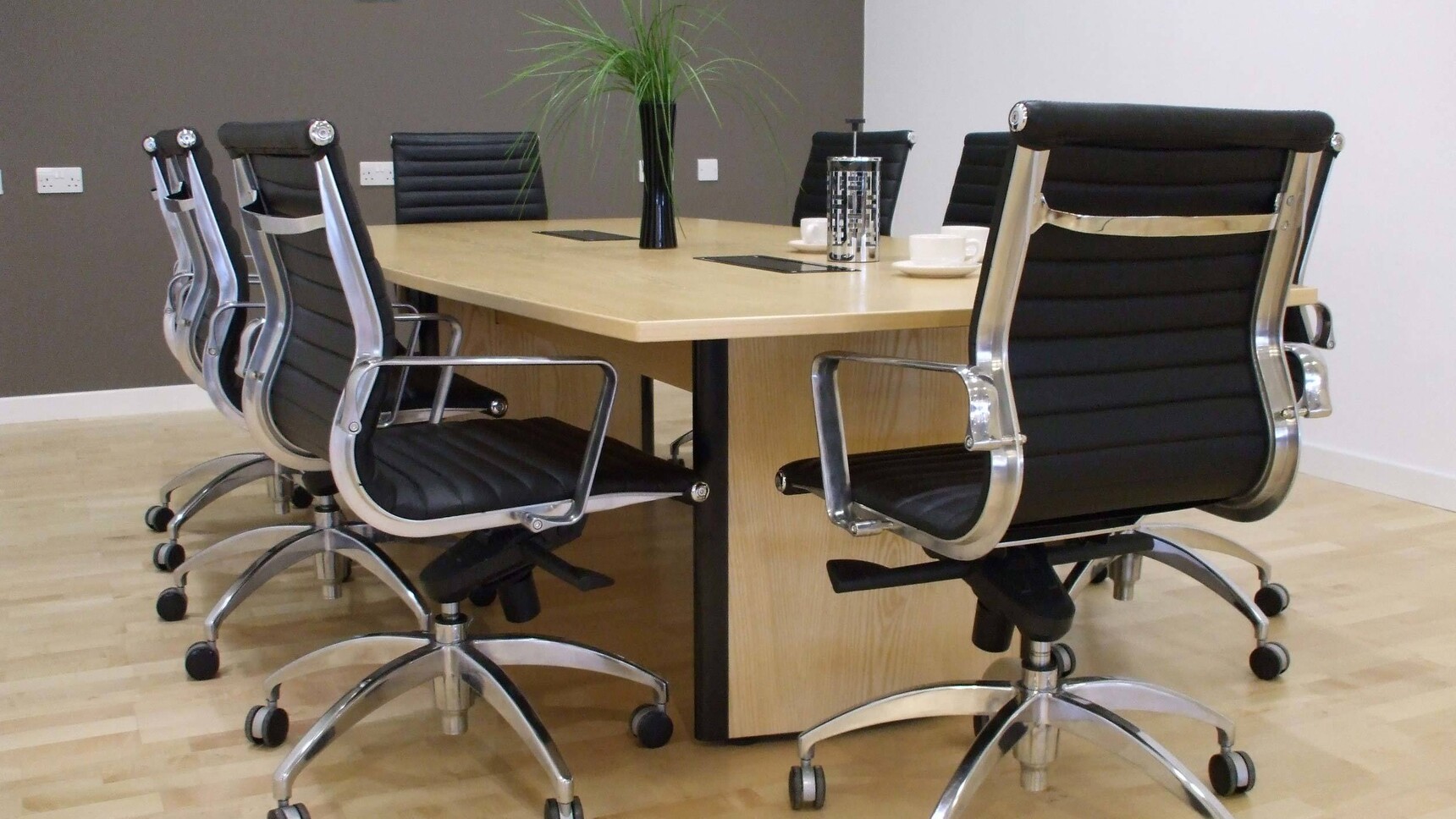 Elite Office Furniture Aerofoil Boardroom Table With Black Chairs At Table