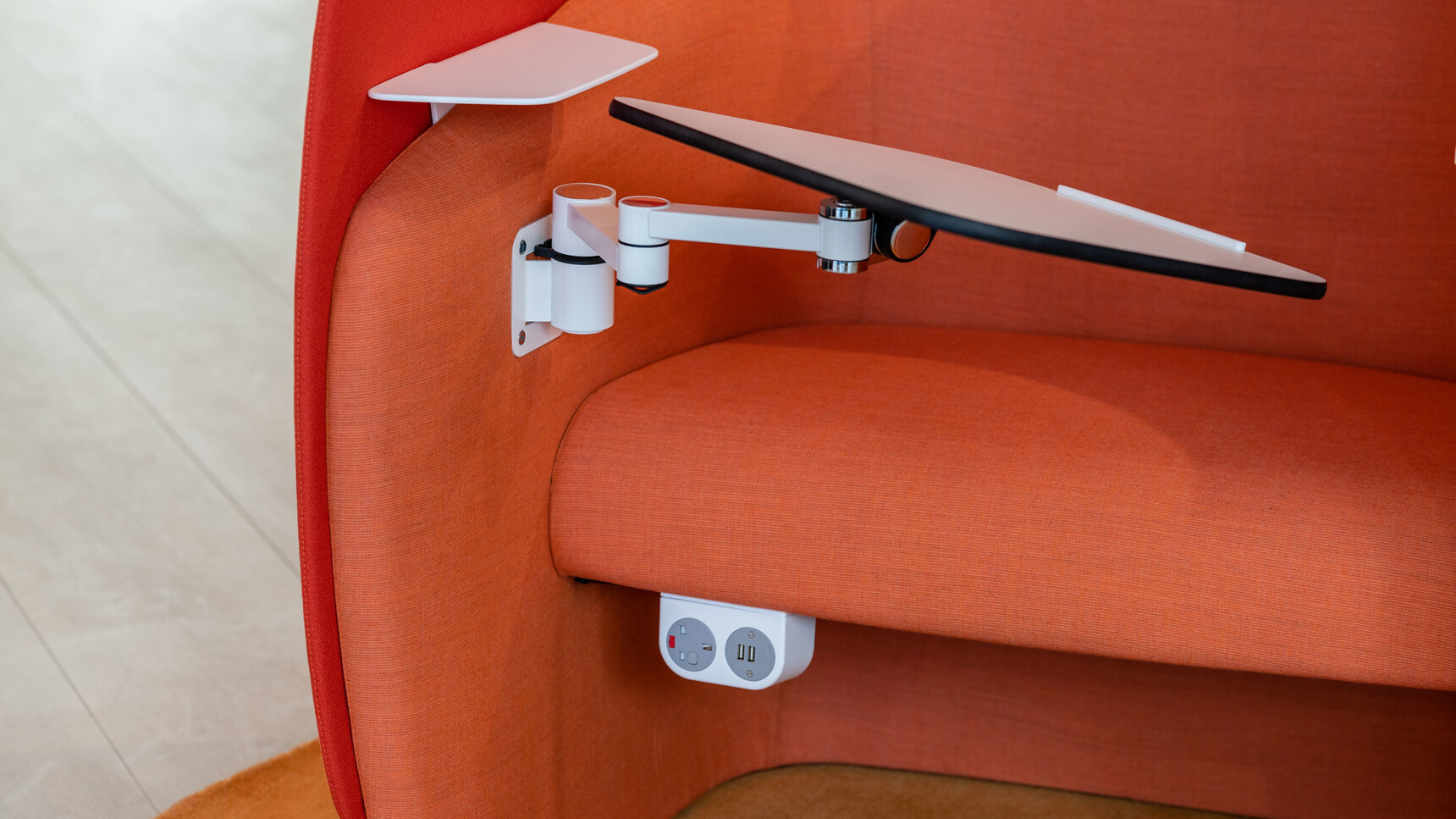Boss Design Mango Workstation with Surround Screen Orange Upholstery Left-Hand Writing Tablet Articulated Steel Arm White Top Finish Plug Socket Detail Image