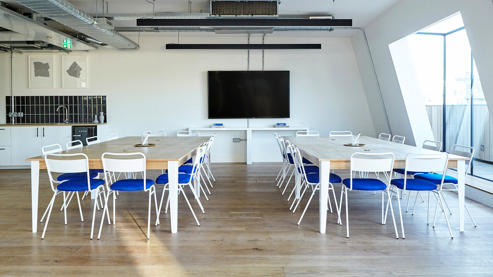Deadgood Working Chairs With Upholstered Seat At Tables Blue Seat Signal White Frame Finish In Breakout Setting