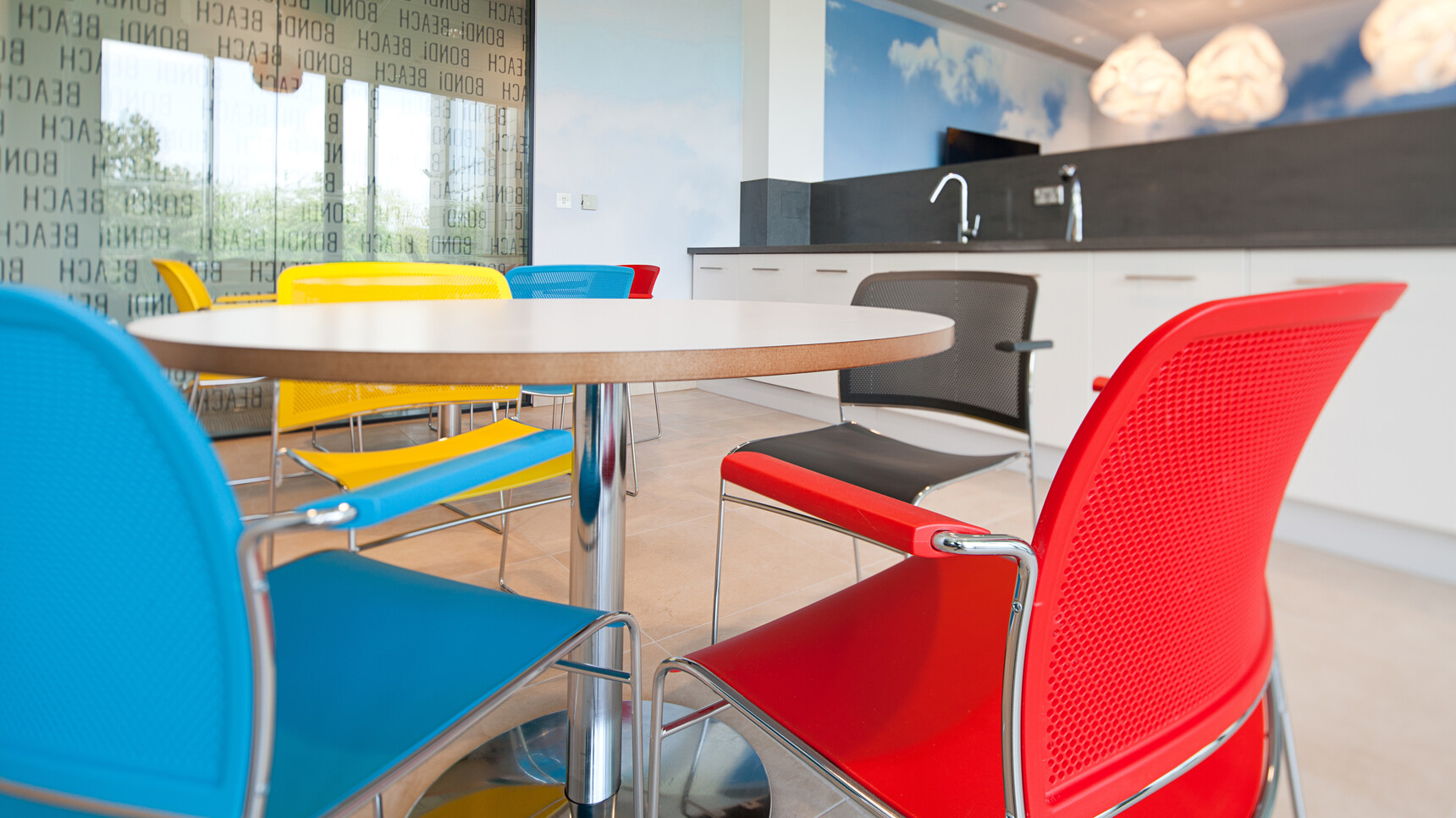 Eight Boss Design Starr Meeting Chairs In Red Black Blue And Yellow At Tables