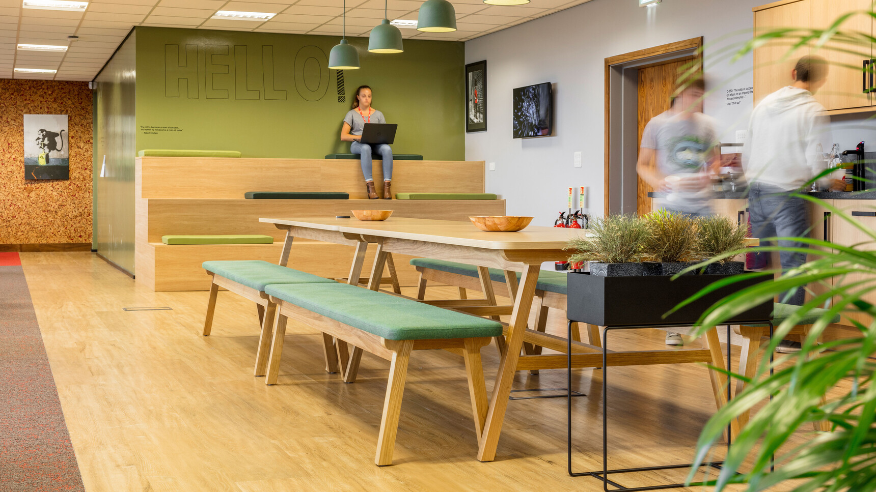 Four Boss Design Agent Benches With Green Upholstery And Wood Finish At Agent Six Leg Dining Height With Wood Finish Showing Office In Use By Three People