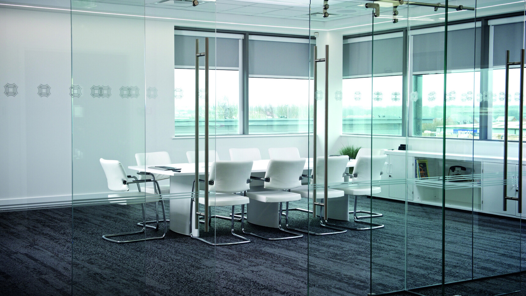 Elite Aerofoil Boardroom Table Two Section Top With White Finish Table Top And Legs With Ten Moda Fully Upholstered Open Cantilever Base Meeting Chair With White Seat And Backrest And Silver Leg Finish In Boardroom