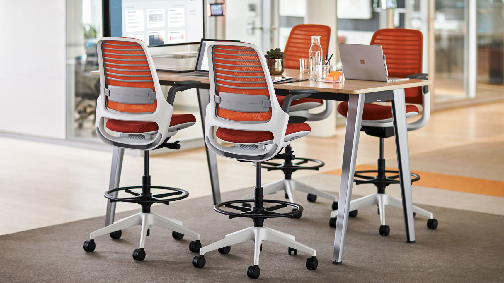 Four Steelcase Draughtsman Office Stools  In Orange Upholstery At Desk
