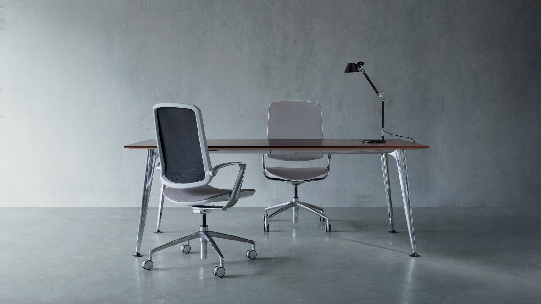Two Boss Design Trinetic Mesh Seat & Back Office Chairs With Dark Grey Upholstery With Grey Frame Backrest And Polished Aluminium Armrests And Polished Aluminium Base On Castors At Desk