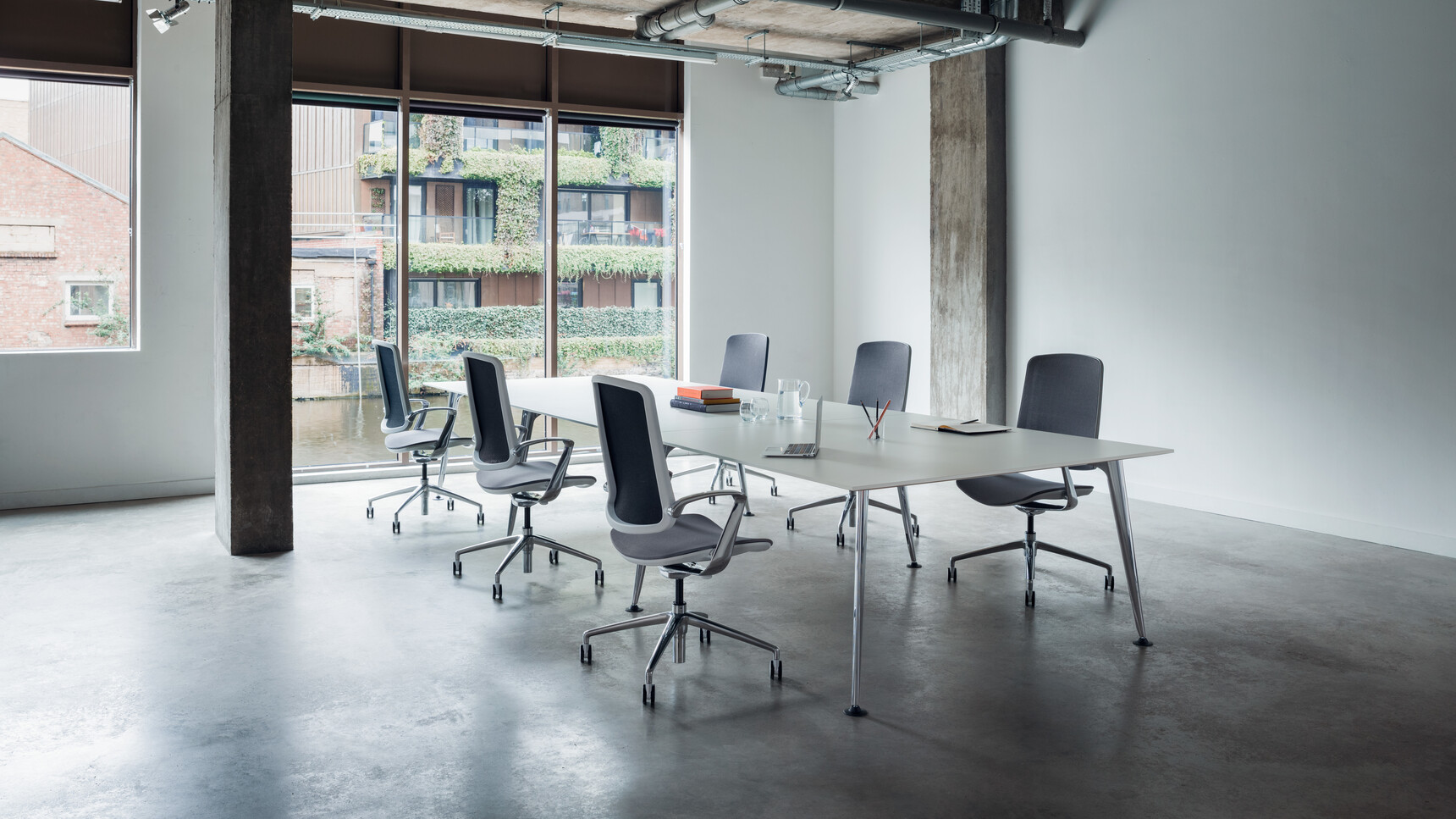 Six Boss Design Trinetic Mesh Seat & Back Office Chairs With Dark Grey Upholstery With White Frame Backrest And Polished Aluminium Armrests And Polished Aluminium Base On Castors At Desk