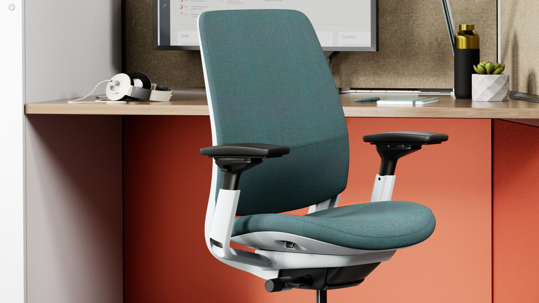 Steelcase Series 2 Upholstered Office Task Chair In Green Upholstery Seagull Frame At Desk Detail Image Facing Away From Desk