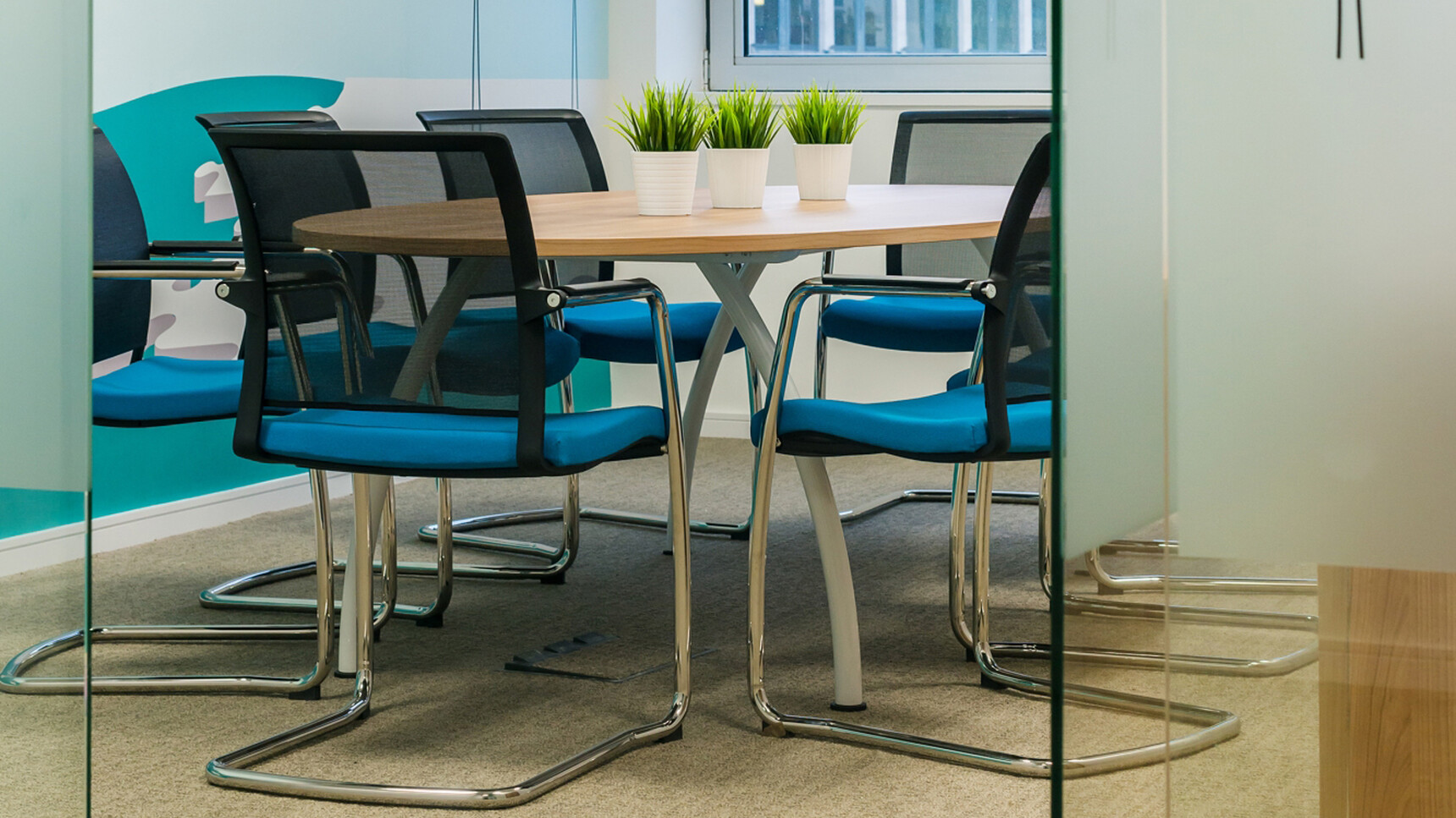 Eight Elite Moda Mesh Back Cantilever Base Meeting Chairs With Black Backrest Finish With Blue Seat Finish And Polished Chrome Base Finish At Elite Meeting Desk In Meeting Room