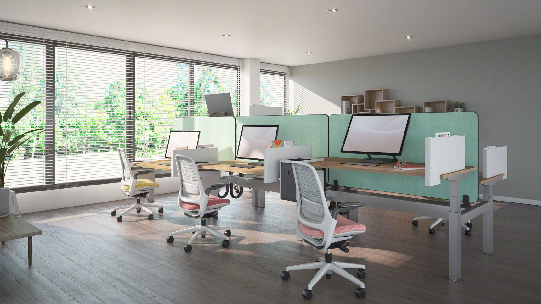 Three Steelcase Migration Height Adjustable Bench Desk With Green Privacy Screens And Wood Table Top Finish And Grey Finish Base With Three Series One Office Chairs Two In Pink And One In Yellow In Office Environment