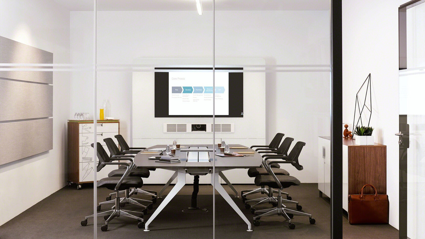Steelcase 4.8 Barrel Conference Table With White Aluminium Legs And Wood Finish With Six Black Qivi Five Star Base Conference Chairs on Castors In A Conference Room