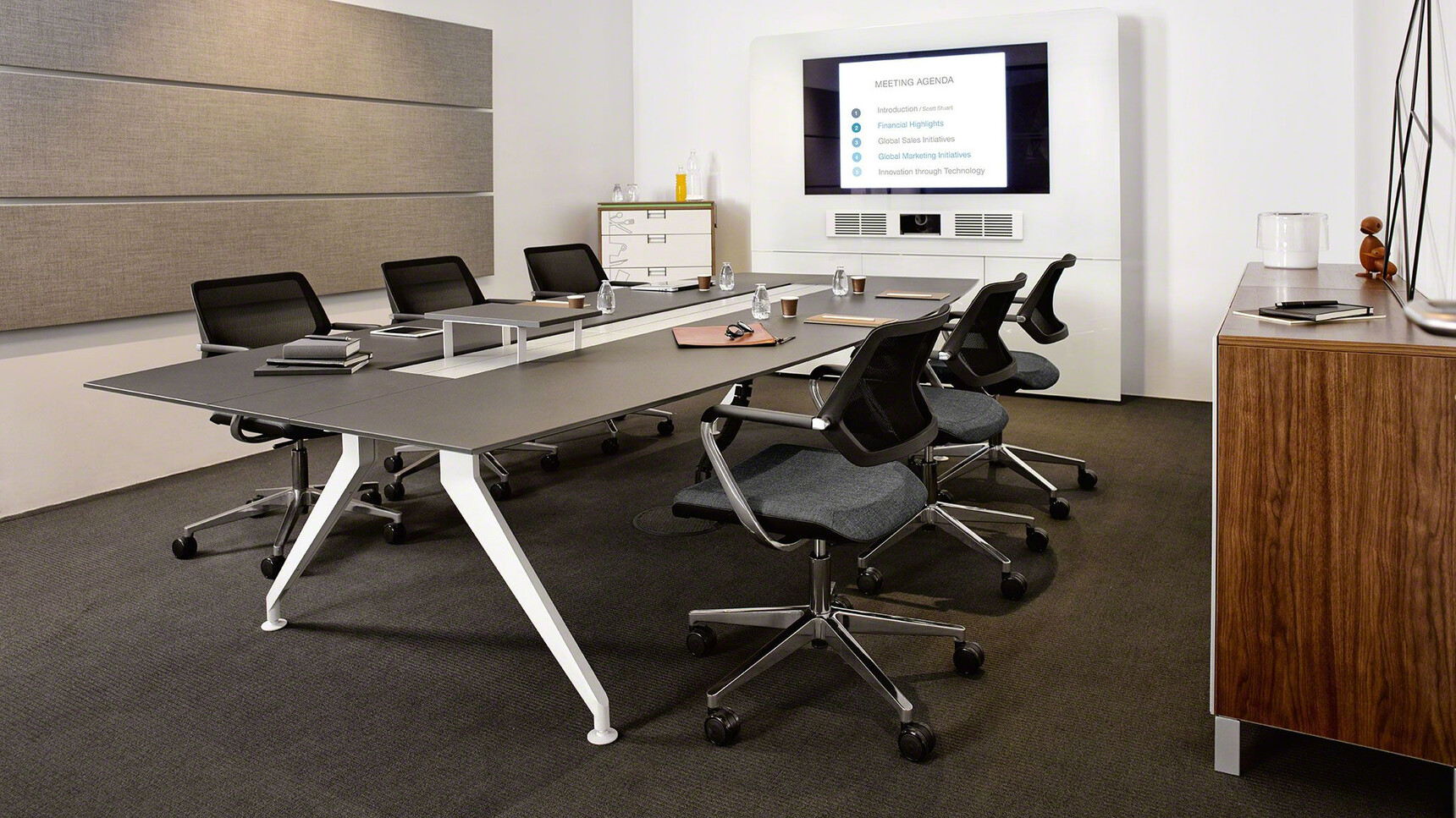 Steelcase 4.8 Barrel Conference Table With White Aluminium Legs And Black Finish With Six Black Qivi Five Star Base Conference Chairs on Castors In A Conference Room