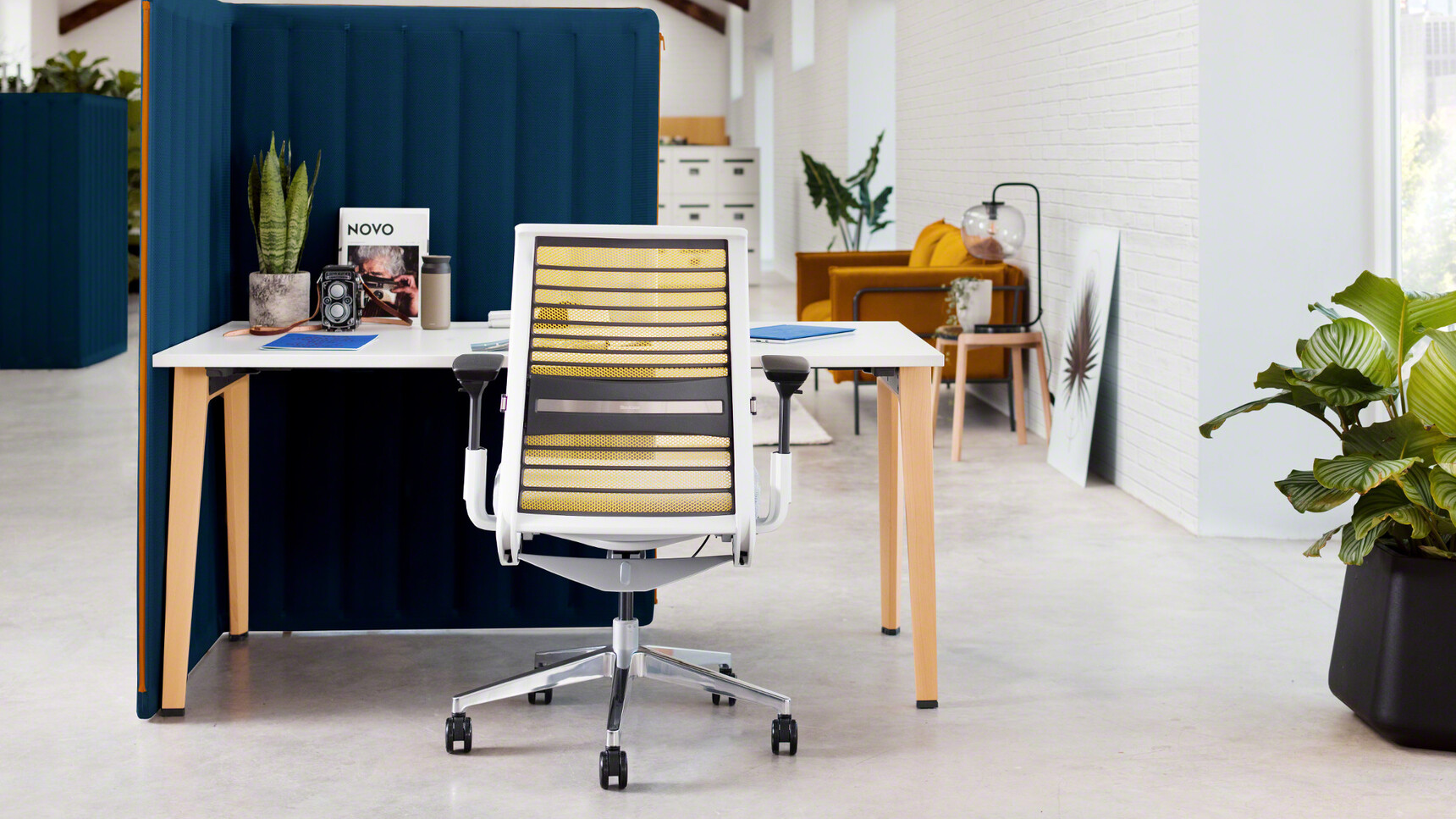 Steelcase B-Free Desk With Wooden Legs And White Table Top Finish With White Think 3D Knit Back Office Chair In Office Environment