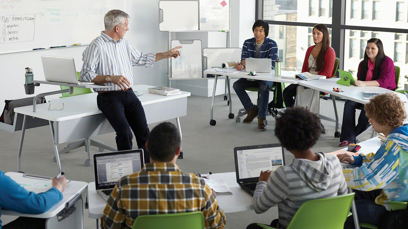 Seven Steelcase Verb Chevron for Two Desks With White Table Top Finish And Grey Leg Finish On Castors Two With Optional White Board Easels Five Without And Lecturers Desk Has The Optional Modesty Panel