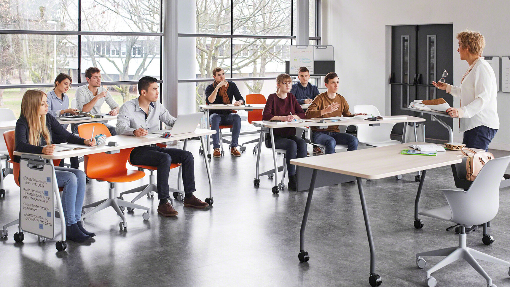 Four Steelcase Verb Rectangular Desks With Wood Table Top Finish And Grey Leg Finish On Castors Two With Optional White Board Easels With Thirteen Node 5 Star Base Chairs And A Verb Chevron for Two Desks